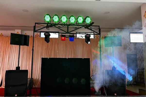Wedding stage lighting setup with LED par lights, profile spots and fog effects for reception decoration in Delhi